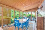 The spacious screen porch has outdoor dining for everyone to enjoy a meal in the fresh air